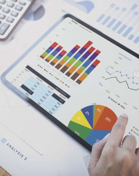 Businesswoman using a tablet to analysis graph company finance strategy statistics success concept and planning for future in office room.